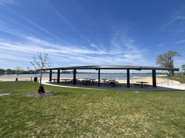 view of home's community with a gazebo, a lawn, and a water view