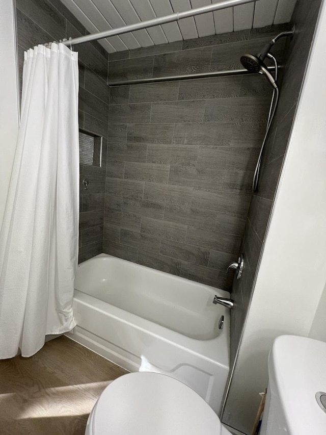 bathroom with toilet, shower / tub combo with curtain, and wood finished floors