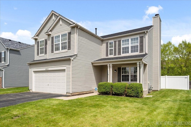 traditional-style home with a chimney, a garage, and driveway