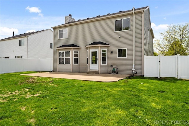 rear view of property featuring a patio, a chimney, and a gate