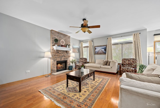 1913 Apple Valley Rd, Bolingbrook, IL 60490 - living area featuring ceiling fan, a brick fireplace, light wood-type flooring, and baseboards