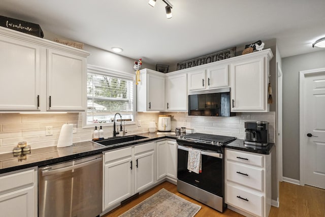 423 W Taylor St W, Dekalb, IL 60115 - kitchen with stainless steel appliances, dark countertops, and white cabinetry