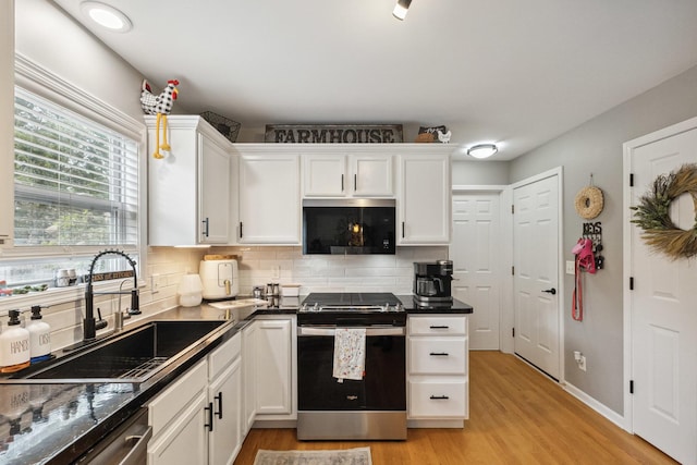 423 W Taylor St W, Dekalb, IL 60115 - kitchen featuring appliances with stainless steel finishes, white cabinets, light wood-style flooring, and tasteful backsplash