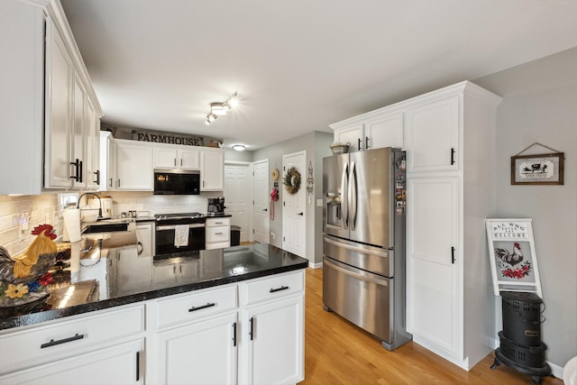 423 W Taylor St W, Dekalb, IL 60115 - kitchen featuring stainless steel appliances, tasteful backsplash, light wood-style flooring, a peninsula, and white cabinetry