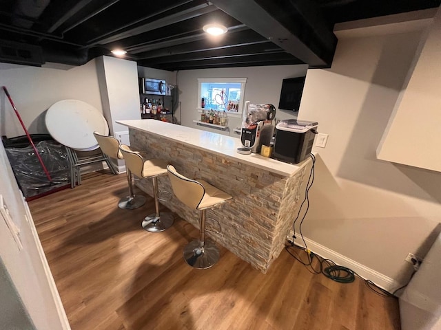 638 Paxton Ave, Calumet City, IL 60409 - indoor bar featuring wood finished floors, baseboards, and stainless steel microwave