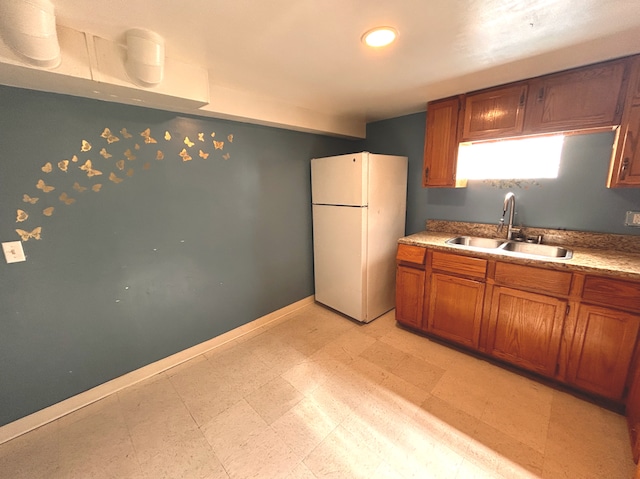 8020 S Mozart St, Chicago, IL 60652 - kitchen with freestanding refrigerator, a sink, brown cabinets, light floors, and baseboards
