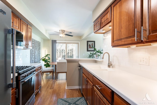 1016 N Knollwood Dr, Palatine, IL 60067 - kitchen featuring a sink, appliances with stainless steel finishes, decorative backsplash, a ceiling fan, and dark wood-style flooring