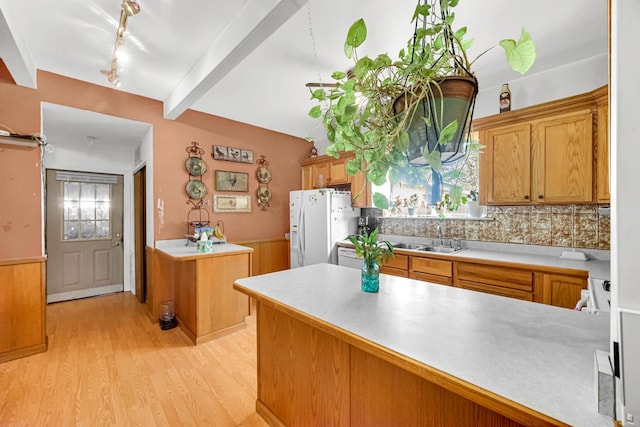 1311 Harvey Ave, Berwyn, IL 60402 - kitchen featuring white refrigerator with ice dispenser, a sink, light wood finished floors, beamed ceiling, and tasteful backsplash