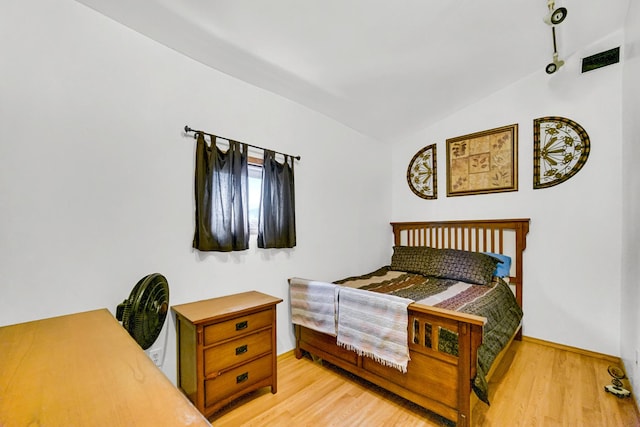 1311 Harvey Ave, Berwyn, IL 60402 - bedroom featuring vaulted ceiling, baseboards, and wood finished floors
