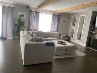 313 Roger Rd, Darien, IL 60561 - living area with wood finished floors, beam ceiling, a fireplace, and baseboards