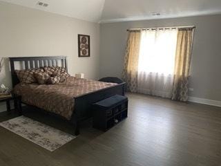 313 Roger Rd, Darien, IL 60561 - bedroom featuring lofted ceiling, wood finished floors, and baseboards