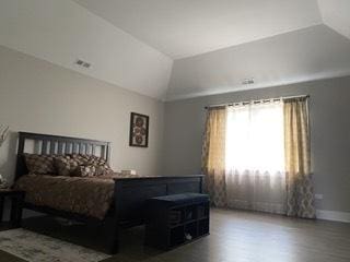 313 Roger Rd, Darien, IL 60561 - bedroom with vaulted ceiling and wood finished floors