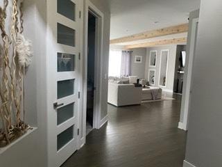 313 Roger Rd, Darien, IL 60561 - hallway featuring dark wood-style flooring and baseboards