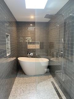 313 Roger Rd, Darien, IL 60561 - bathroom with tile walls, a freestanding tub, and a tile shower