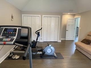313 Roger Rd, Darien, IL 60561 - exercise area featuring vaulted ceiling, wood finished floors, and baseboards