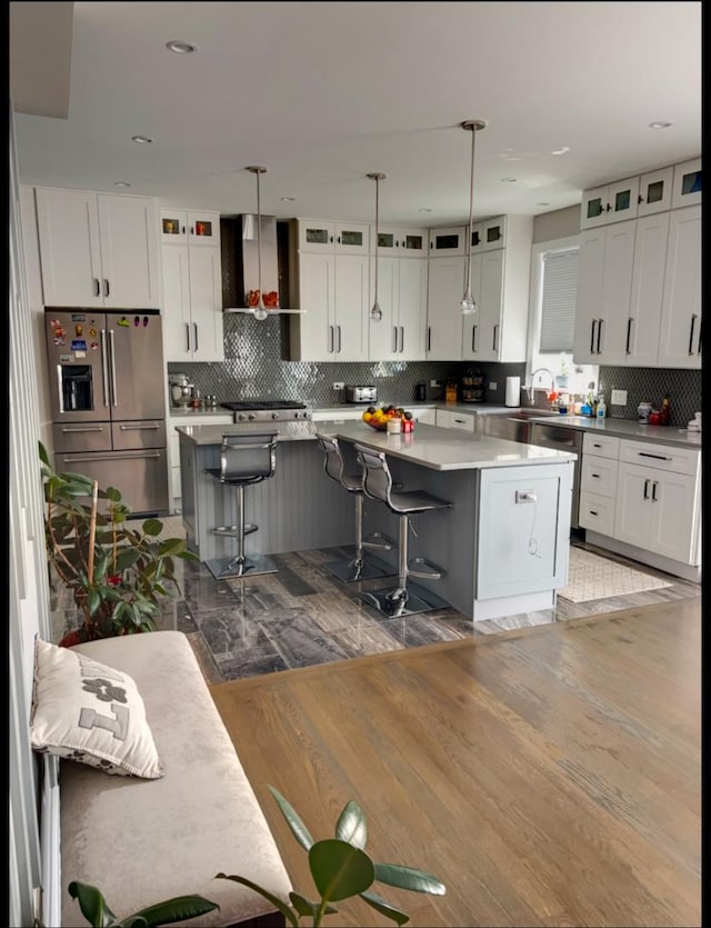 313 Roger Rd, Darien, IL 60561 - kitchen with appliances with stainless steel finishes, wall chimney range hood, a center island, backsplash, and recessed lighting