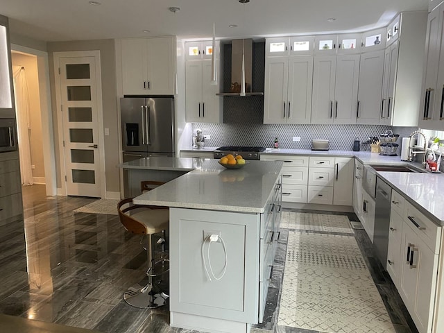 313 Roger Rd, Darien, IL 60561 - kitchen with a kitchen island, stainless steel appliances, wall chimney range hood, a sink, and decorative backsplash