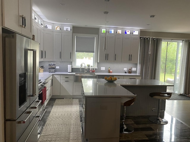 313 Roger Rd, Darien, IL 60561 - kitchen featuring a sink, stainless steel fridge with ice dispenser, a kitchen island, backsplash, and recessed lighting
