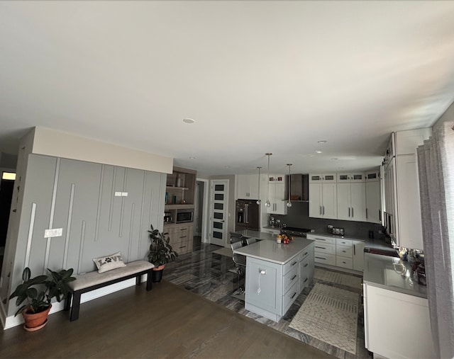 313 Roger Rd, Darien, IL 60561 - kitchen featuring dark wood-type flooring, a kitchen island, white cabinets, stainless steel appliances, and light countertops