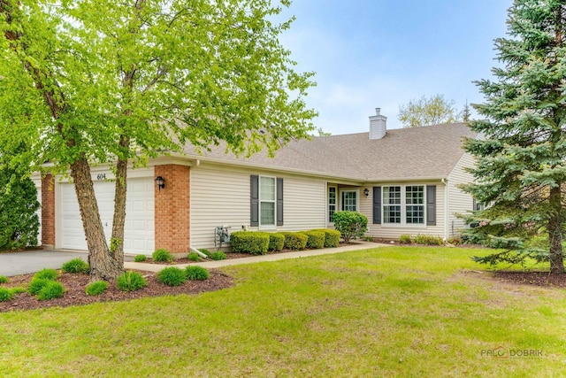 604 S Essington Dr, Round Lake, IL 60073 - view of front facade with a chimney, a front yard, driveway, and a shingled roof