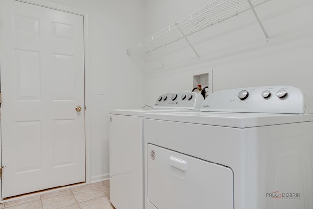 604 S Essington Dr, Round Lake, IL 60073 - laundry area featuring washer and dryer, light tile patterned flooring, and baseboards