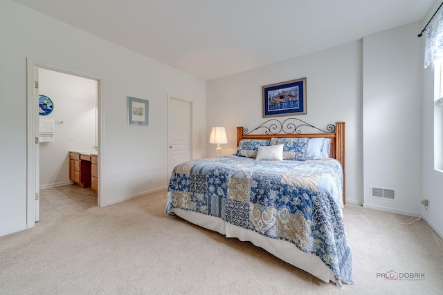 604 S Essington Dr, Round Lake, IL 60073 - bedroom featuring light colored carpet, baseboards, and ensuite bath