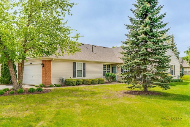 604 S Essington Dr, Round Lake, IL 60073 - view of front facade featuring a garage, a front yard, driveway, and brick siding