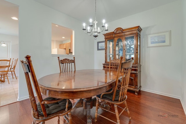 604 S Essington Dr, Round Lake, IL 60073 - dining area featuring a chandelier, wood finished floors, baseboards, and recessed lighting