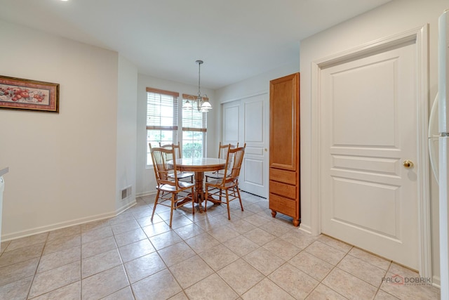 604 S Essington Dr, Round Lake, IL 60073 - dining space featuring a chandelier, light tile patterned floors, and baseboards