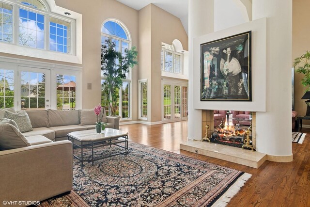 80 Gaelic Ct, Inverness, IL 60010 - living room featuring a towering ceiling, wood finished floors, and baseboards