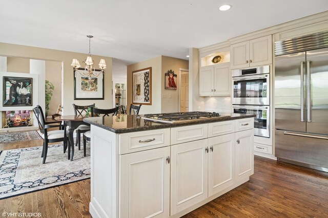 80 Gaelic Ct, Inverness, IL 60010 - kitchen with stainless steel appliances, dark wood-type flooring, a chandelier, a center island, and pendant lighting