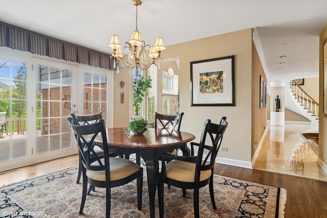80 Gaelic Ct, Inverness, IL 60010 - dining space featuring baseboards, wood finished floors, a chandelier, french doors, and healthy amount of natural light