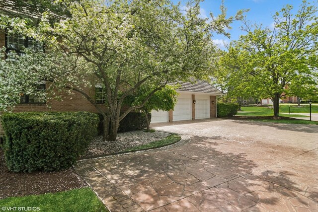 80 Gaelic Ct, Inverness, IL 60010 - view of side of home with driveway, brick siding, and an attached garage