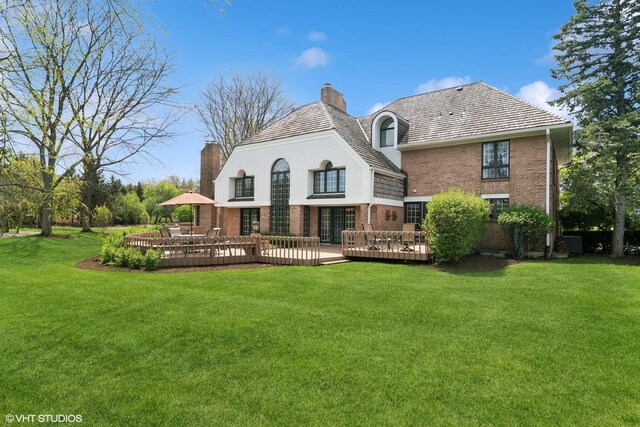 80 Gaelic Ct, Inverness, IL 60010 - back of property with a chimney, brick siding, a wooden deck, and a lawn