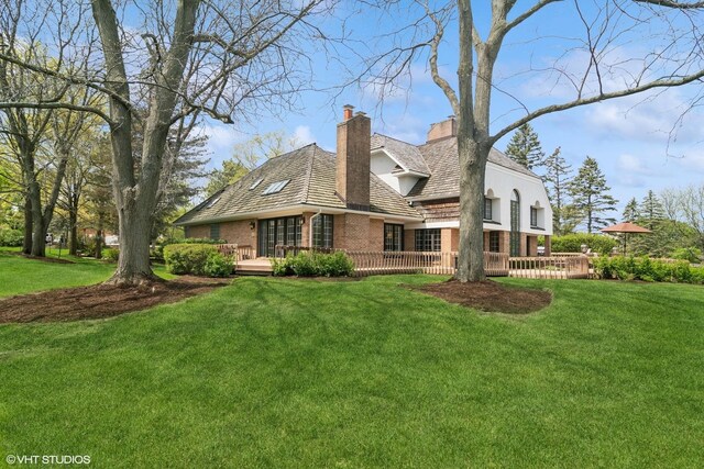 80 Gaelic Ct, Inverness, IL 60010 - back of property with brick siding, a chimney, a wooden deck, and a yard
