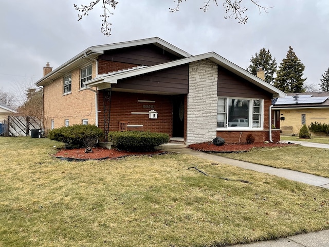 10724 Leclaire Ave, Oak Lawn, IL 60453 - view of front of home with a chimney, brick siding, a front yard, and central AC unit