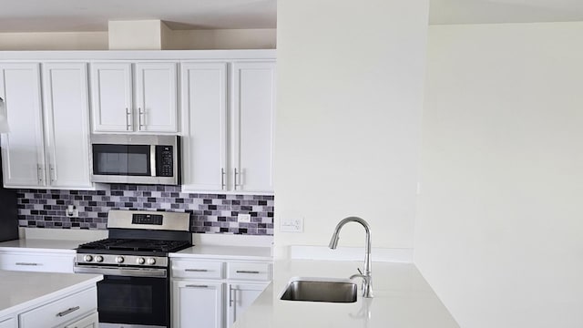 858 Finley Dr, Aurora, IL 60504 - kitchen featuring appliances with stainless steel finishes, a sink, light countertops, and white cabinets