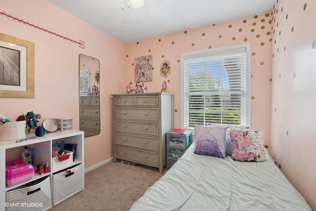 bedroom featuring light carpet and baseboards