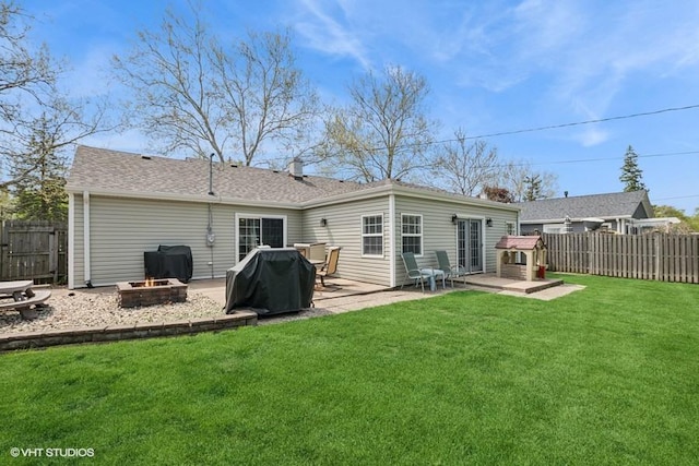 back of house with a fire pit and a patio