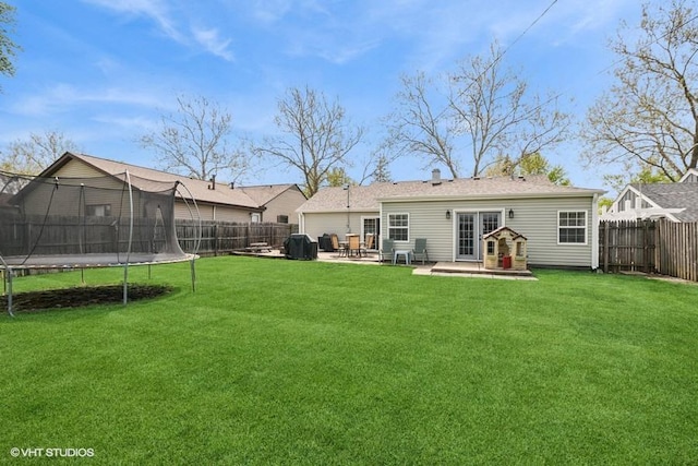 back of house featuring a trampoline, a patio, and french doors