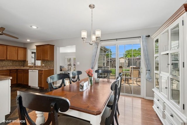 dining area with a chandelier, light wood-type flooring, a ceiling fan, and recessed lighting