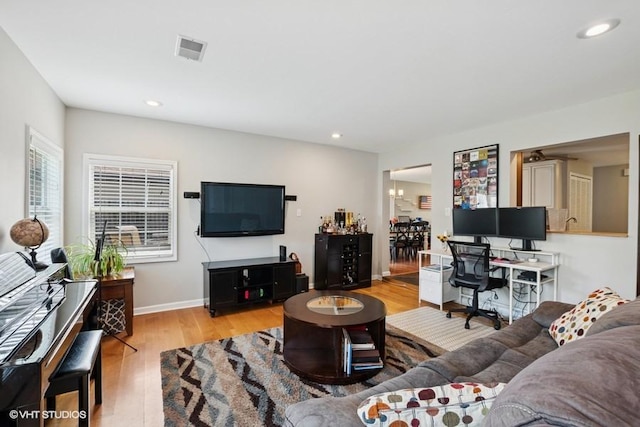living area featuring light wood-style flooring, recessed lighting, and baseboards