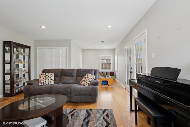 living area featuring light wood-type flooring, french doors, recessed lighting, and baseboards