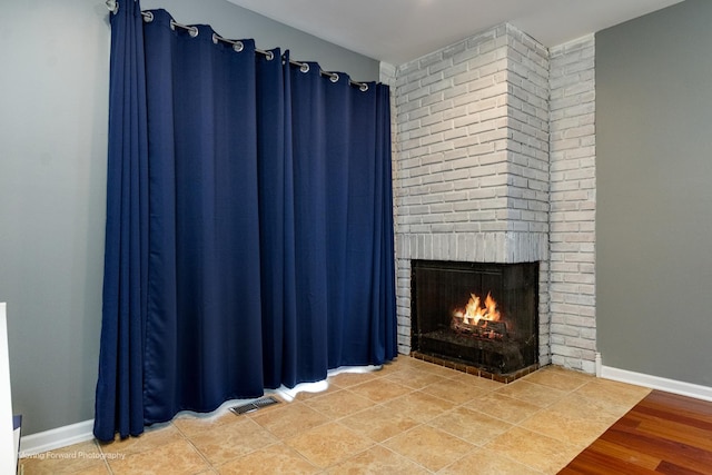 37 W Devon Ave, Glendale Heights, IL 60139 - detailed view of a brick fireplace, baseboards, and wood finished floors