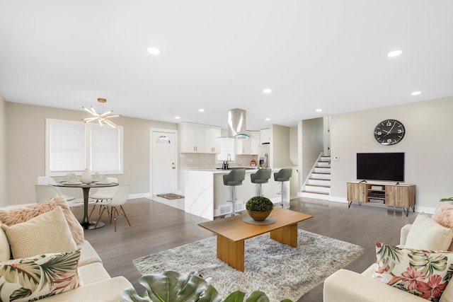 living room with light wood-type flooring, recessed lighting, stairway, baseboards, and a chandelier