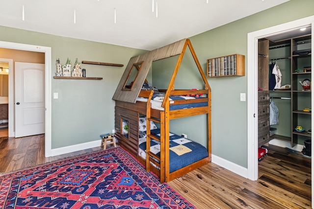 711 S River Rd Unit 503, Des Plaines, IL 60016 - bedroom with baseboards, wood finished floors, a spacious closet, and a closet