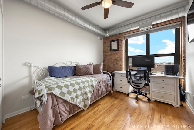 1735 W Diversey Pkwy Unit 416, Chicago, IL 60614 - bedroom featuring a desk, baseboards, light wood-style floors, brick wall, and a ceiling fan
