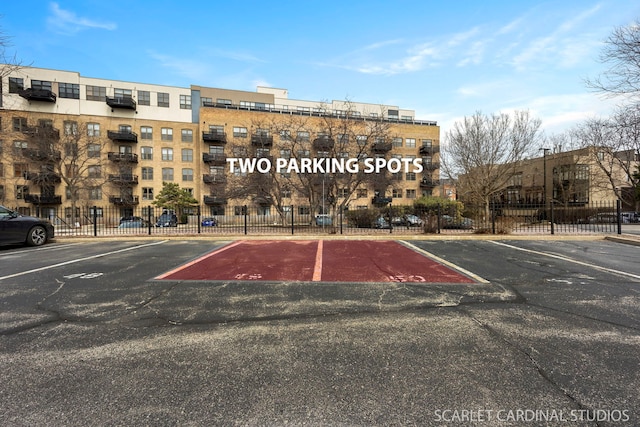 1735 W Diversey Pkwy Unit 416, Chicago, IL 60614 - view of building exterior with uncovered parking and fence