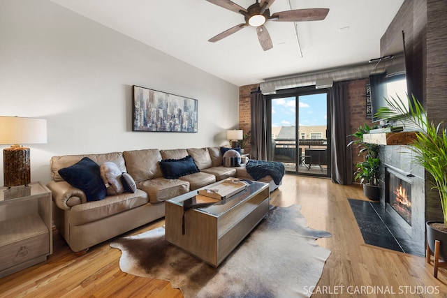 1735 W Diversey Pkwy Unit 416, Chicago, IL 60614 - living room featuring a ceiling fan, light wood finished floors, a high end fireplace, and vaulted ceiling