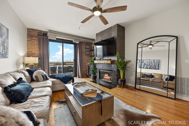 1735 W Diversey Pkwy Unit 416, Chicago, IL 60614 - living room featuring a ceiling fan, wood finished floors, and a fireplace